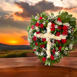 Heart-shaped floral arrangement with red and white flowers