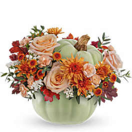 Autumn floral arrangement in a pale green pumpkin vase