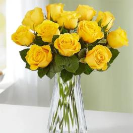 Yellow roses arranged in a clear glass vase
