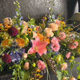 Large mixed bouquet with pink lilies, roses, and blue flowers