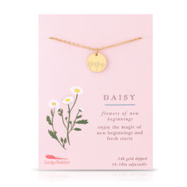 Gold disc daisy necklace on a pink card with illustrated white daisies and text.
