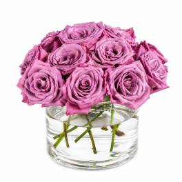 Pink roses arranged in a clear glass vase