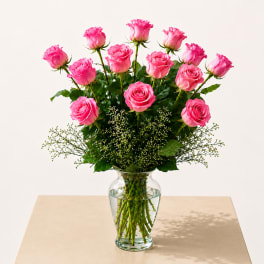 Pink roses arranged in a clear glass vase