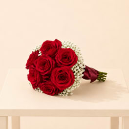 Bouquet of red roses with white baby's breath and burgundy ribbon