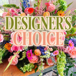 Colorful mixed flower arrangement with a "Designer’s Choice" sign
