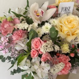Mixed bouquet with roses, lilies, and orchids in pink, white, and yellow