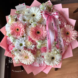Pink and white bouquet with gerbera daisies and roses wrapped in pink paper
