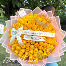 Large bouquet of yellow roses with a crown and ribbon banner