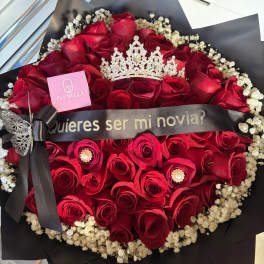 Bouquet of red roses with a black ribbon and crown topper