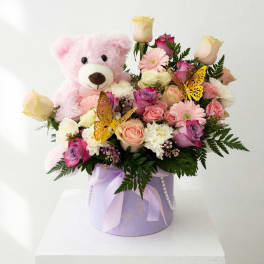 Pink teddy bear with a pastel rose bouquet in a lavender hatbox