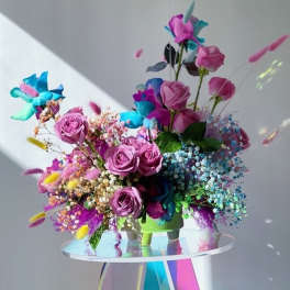 Bouquet of pink roses with bright blue and purple flowers