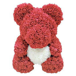 Teddy bear made of red roses with a white heart on its chest