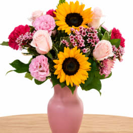 Pink and yellow mixed bouquet in a pink vase