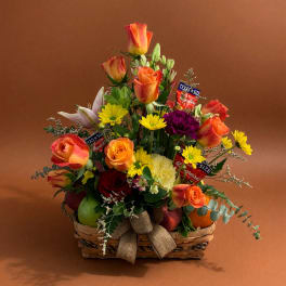 Basket arrangement of orange roses, lilies, and yellow daisies