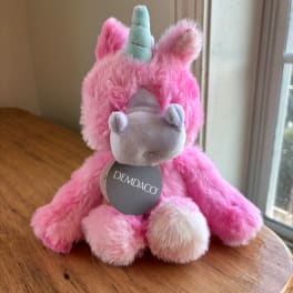 Pink plush unicorn toy with a blue horn and gray snout