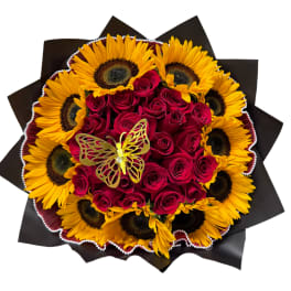 Bouquet of red roses and sunflowers with a butterfly decoration