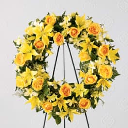 Yellow floral wreath on a black stand