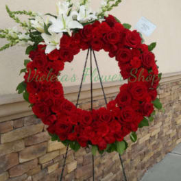 Red rose wreath with white lilies on a standing easel