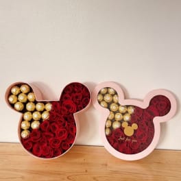 Mickey-shaped gift boxes filled with red roses and gold chocolates