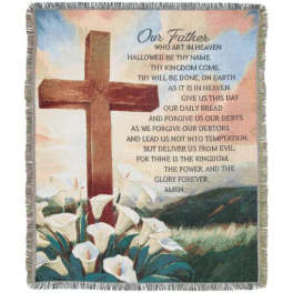 Fringed blanket with a cross, calla lilies, and the Lord's Prayer text