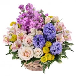 Mixed pastel flower basket with roses, alstroemeria, and purple blooms
