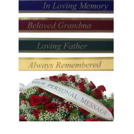 Red rose funeral arrangement with memorial ribbon