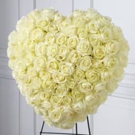 Heart-shaped bouquet of cream roses on a stand