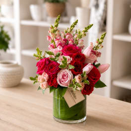 Pink and red rose arrangement in a glass vase