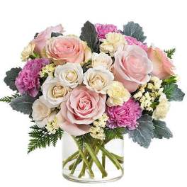 Bouquet of pink and white roses with carnations in a clear glass vase