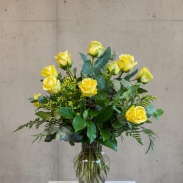 Yellow roses arranged in a clear glass vase