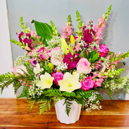 Pink and white mixed flower arrangement in a white vase