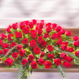 Large arrangement of red roses with greenery