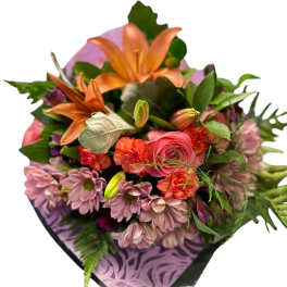 Bouquet of orange lilies, pink roses, and mauve daisies in purple wrap