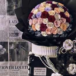 Large bouquet of multicolored roses wrapped in black paper