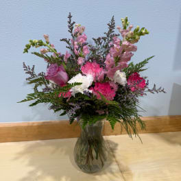 Pink and white mixed bouquet in a clear glass vase