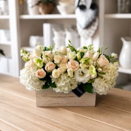 Cream and blush flower arrangement in a wooden box