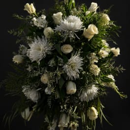 White roses and chrysanthemums arranged in a large cascading bouquet