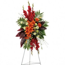 Standing floral spray with red and orange flowers on an easel