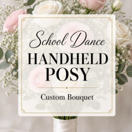 Handheld bouquet of pale pink and white roses with baby's breath