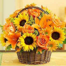 Basket of orange roses, sunflowers, and lilies
