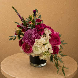 Pink and white mixed flower arrangement in a clear glass vase
