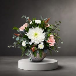 White and pink floral arrangement in a metallic vase