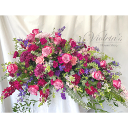 Large pink and purple mixed flower arrangement with roses and carnations