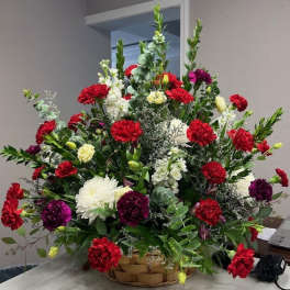 Large basket arrangement of red, white, and purple flowers