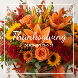 Autumn flower basket with orange lilies, roses, and sunflowers