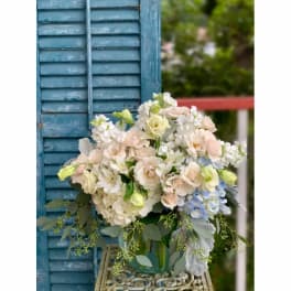 Soft pastel bouquet in a glass vase with white and blush flowers