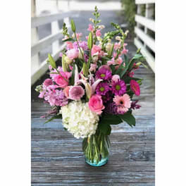 Pink and white mixed flower bouquet in a glass vase