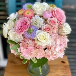 Pink and white mixed flower bouquet in a glass vase