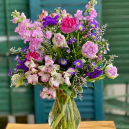 Mixed pink and purple bouquet in a clear glass vase