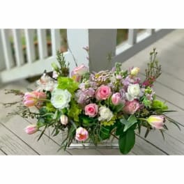 Pink and white floral arrangement in a low rectangular vase